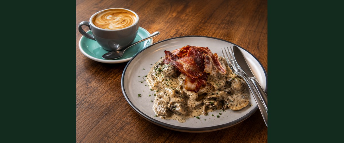 Don Luciano breakfast — bacon and mushrooms in a creamy sauce with a coffee