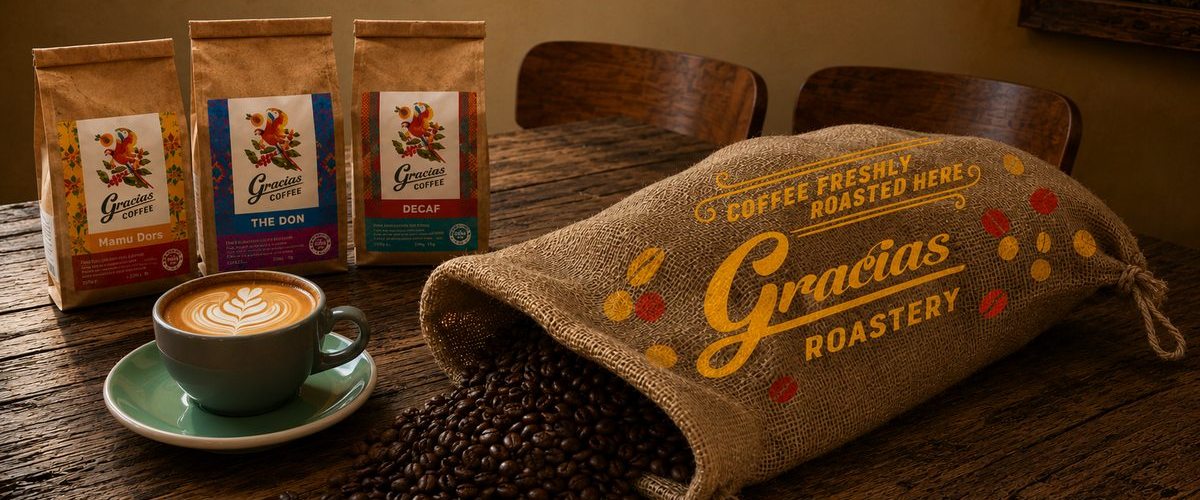 Gracias Roastery — freshly roasted beans, branded bags and a flat white on the bench